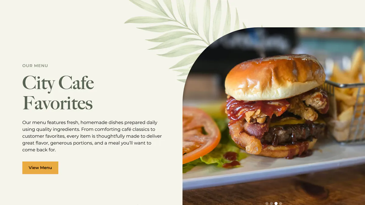 The City Cafe Favorites panel on the homepage: an Our Menu label, a paragraph about fresh, homemade dishes prepared daily with generous portions, a gold View Menu button, and a large arched photo of a bacon cheeseburger topped with barbecue sauce and onion rings beside a basket of fries.
