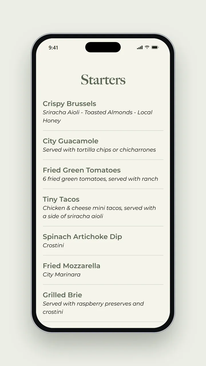 The City Café menu on a phone, showing the Starters heading and dishes including Crispy Brussels with sriracha aioli, toasted almonds and local honey, City Guacamole with tortilla chips or chicharrones, Fried Green Tomatoes, Tiny Tacos, Spinach Artichoke Dip, Fried Mozzarella and Grilled Brie, each with a short italic description.