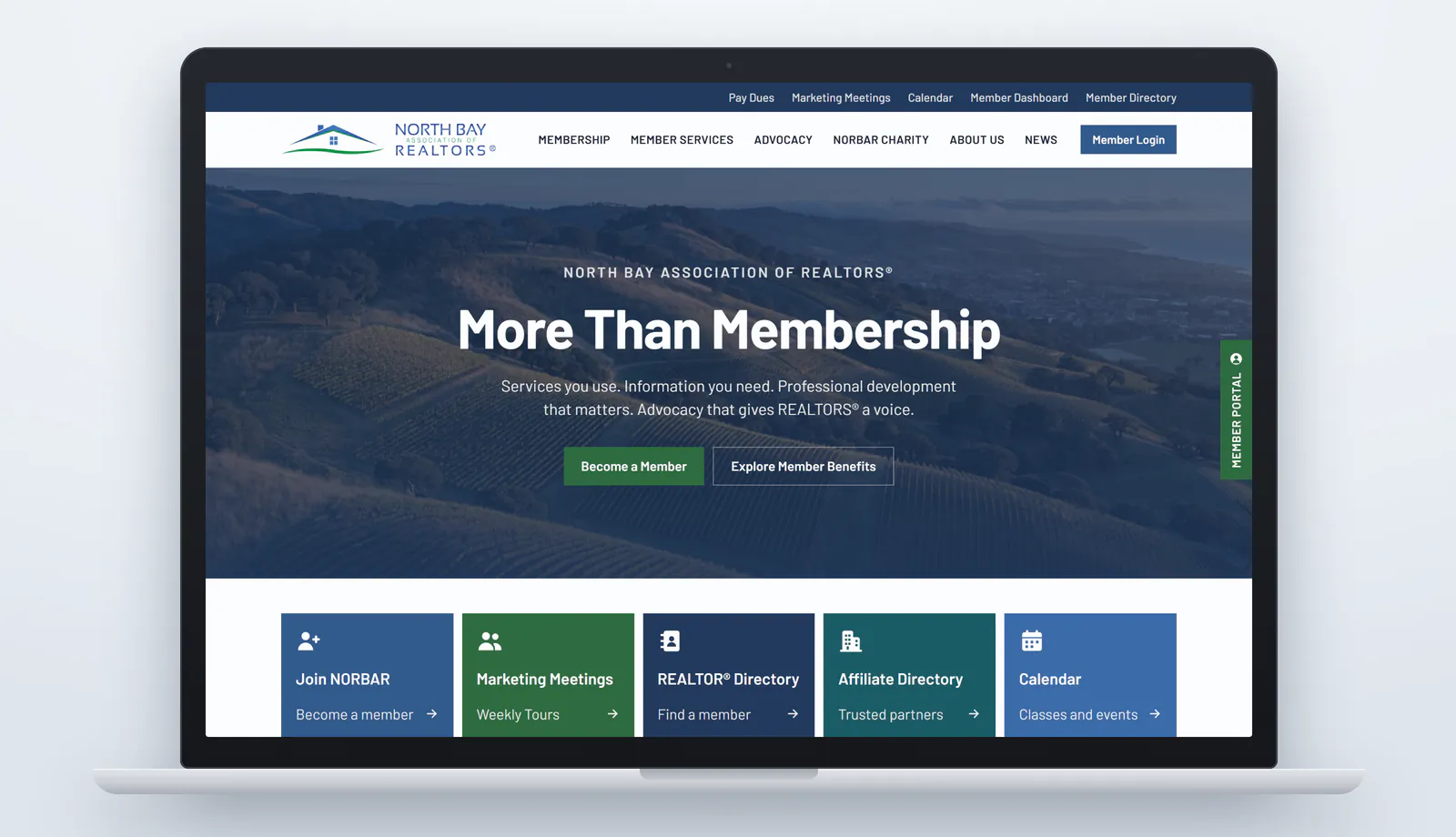 The new northbayrealtors.org homepage on a laptop: a dark blue utility bar with Pay Dues, Marketing Meetings, Calendar, Member Dashboard and Member Directory links, the North Bay Association of REALTORS® logo beside a menu of Membership, Member Services, Advocacy, NORBAR Charity, About Us and News, a Member Login button, and the headline More Than Membership over a blue-tinted photo of North Bay hills, with Become a Member and Explore Member Benefits buttons and a row of five colored quick-link tiles below.