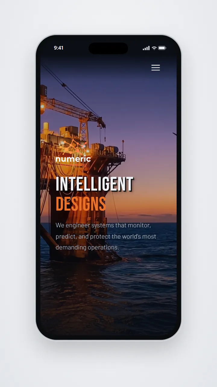 Numeric Engineering's homepage on a phone, with a menu button at the top right, the Numeric Engineering logo, the headline Intelligent Designs, and the line We engineer systems that monitor, predict, and protect the world's most demanding operations over an image of an offshore platform at sunset.